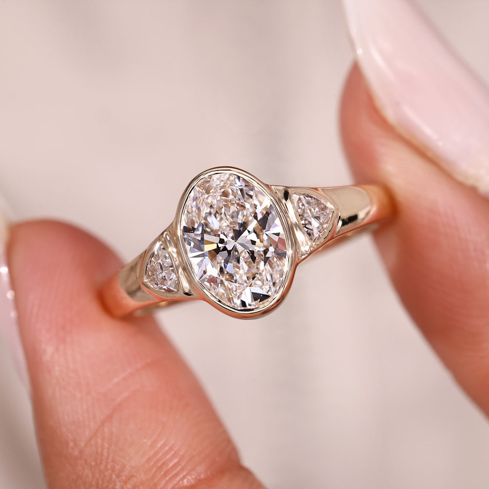 Oval center diamond ring with side trillion stones.