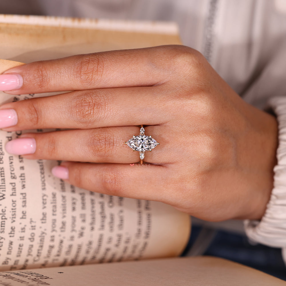 Marquise diamond ring with two marquise side stones.
