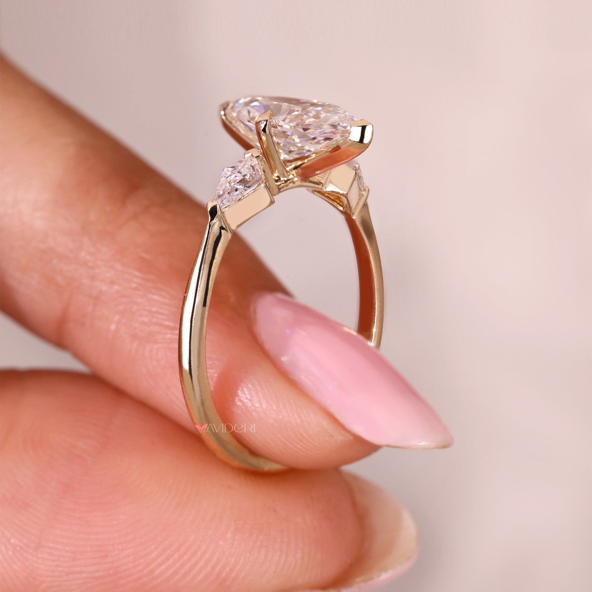 Three stone ring with tapered shank and v prong setting.
