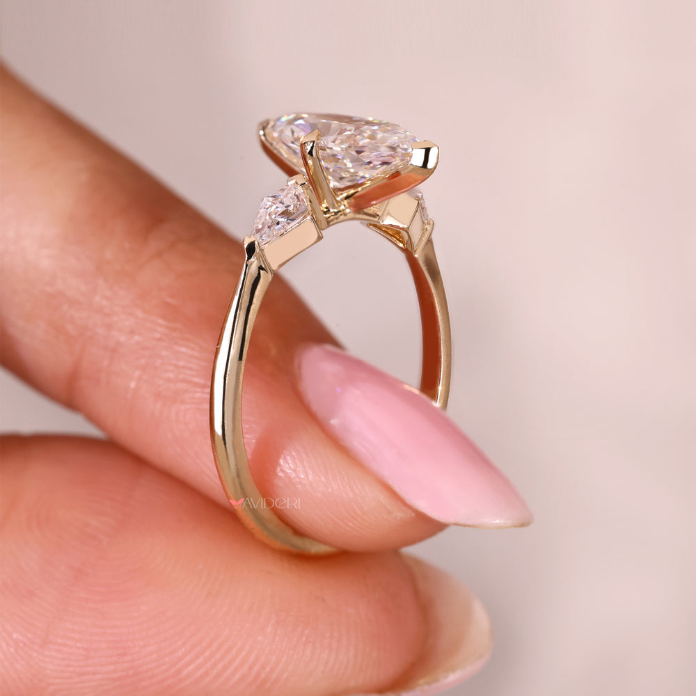 Three stone ring with tapered shank and v prong setting.
