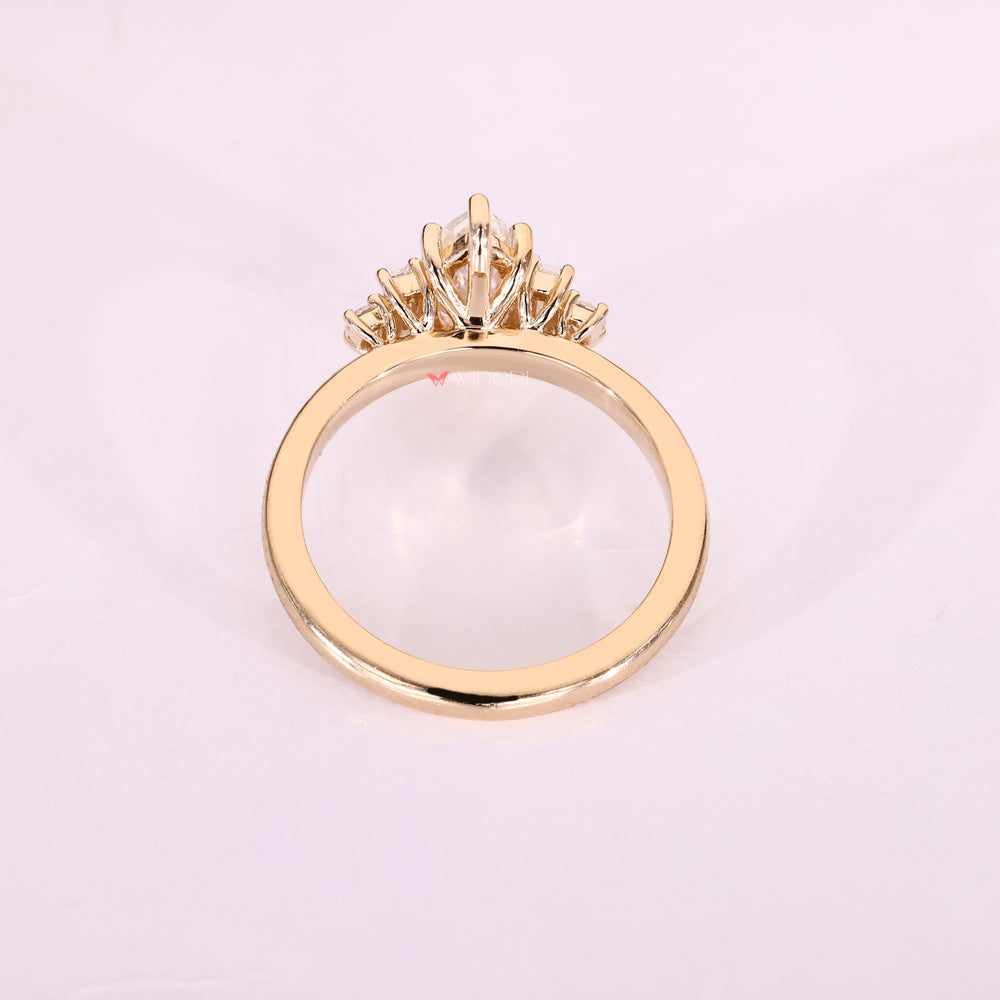 Yellow gold ring with marquise moissanite and side stones.