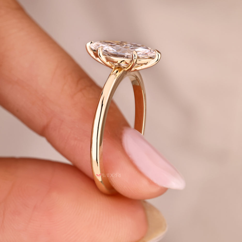 Marquise cut diamond ring with six claw prong setting.
