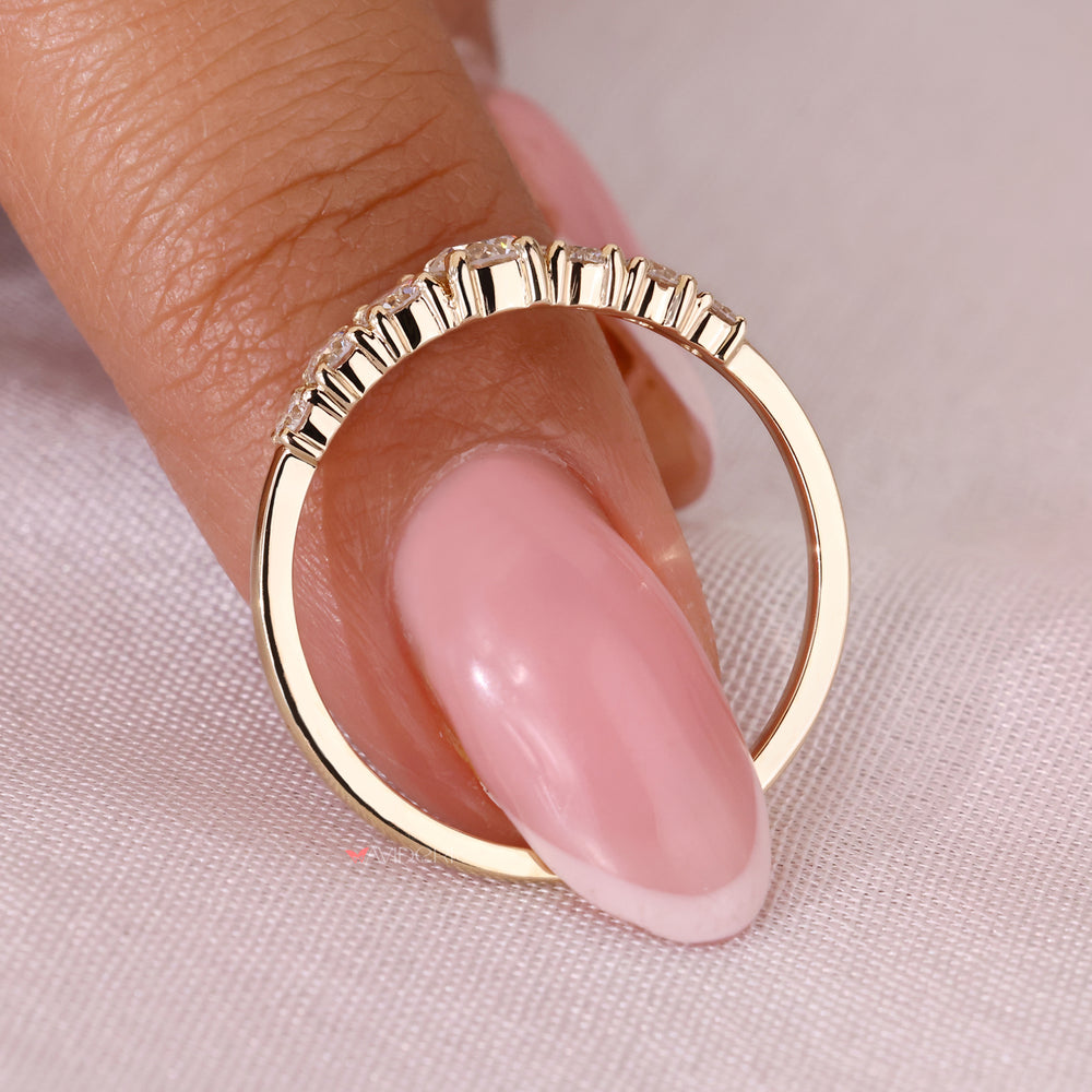 Yellow gold wedding band featuring round diamonds
