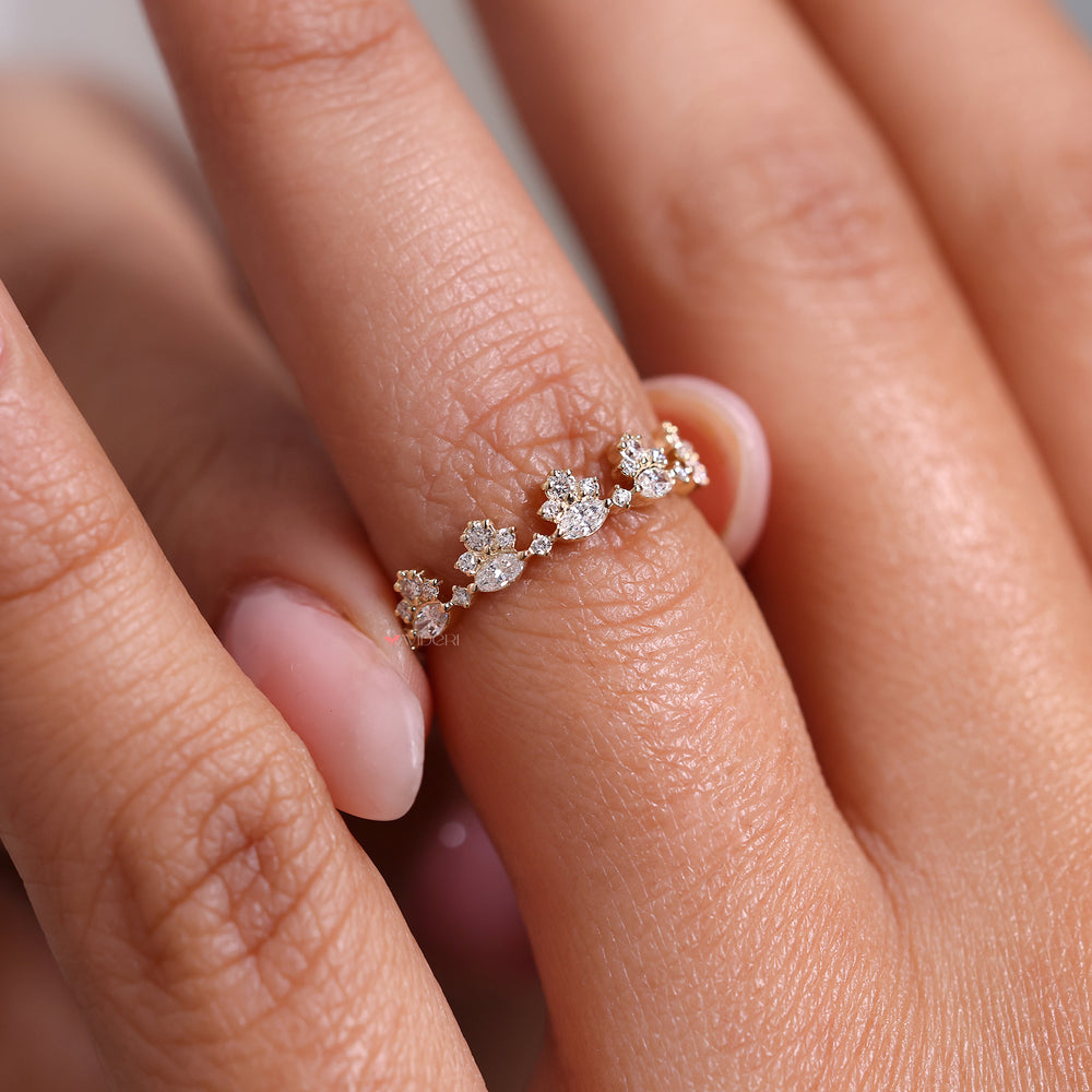 Half eternity wedding band featuring marquise and round diamonds in a shared prong style.
