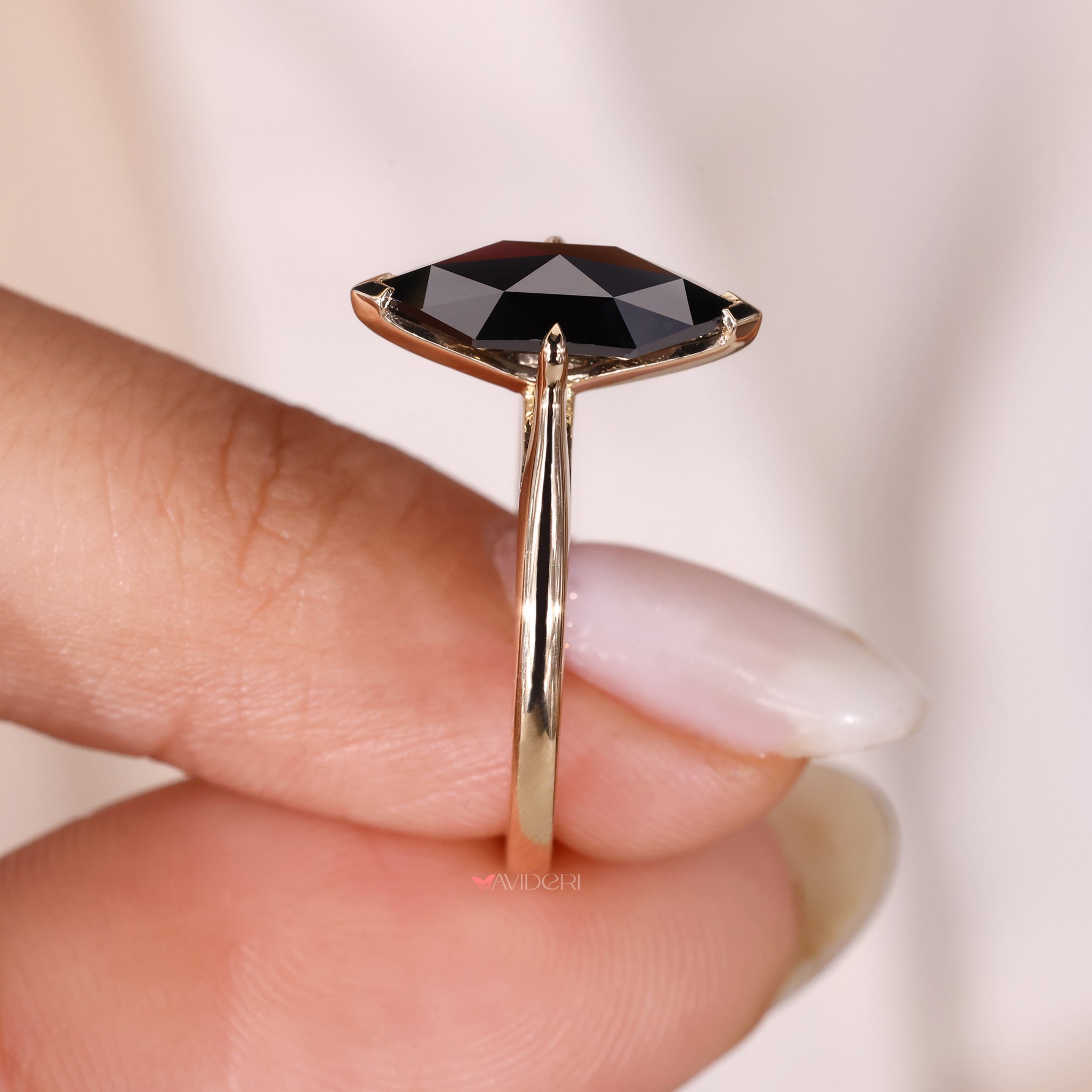  v-prong cathedral setting engagement ring with a moissanite stone.
