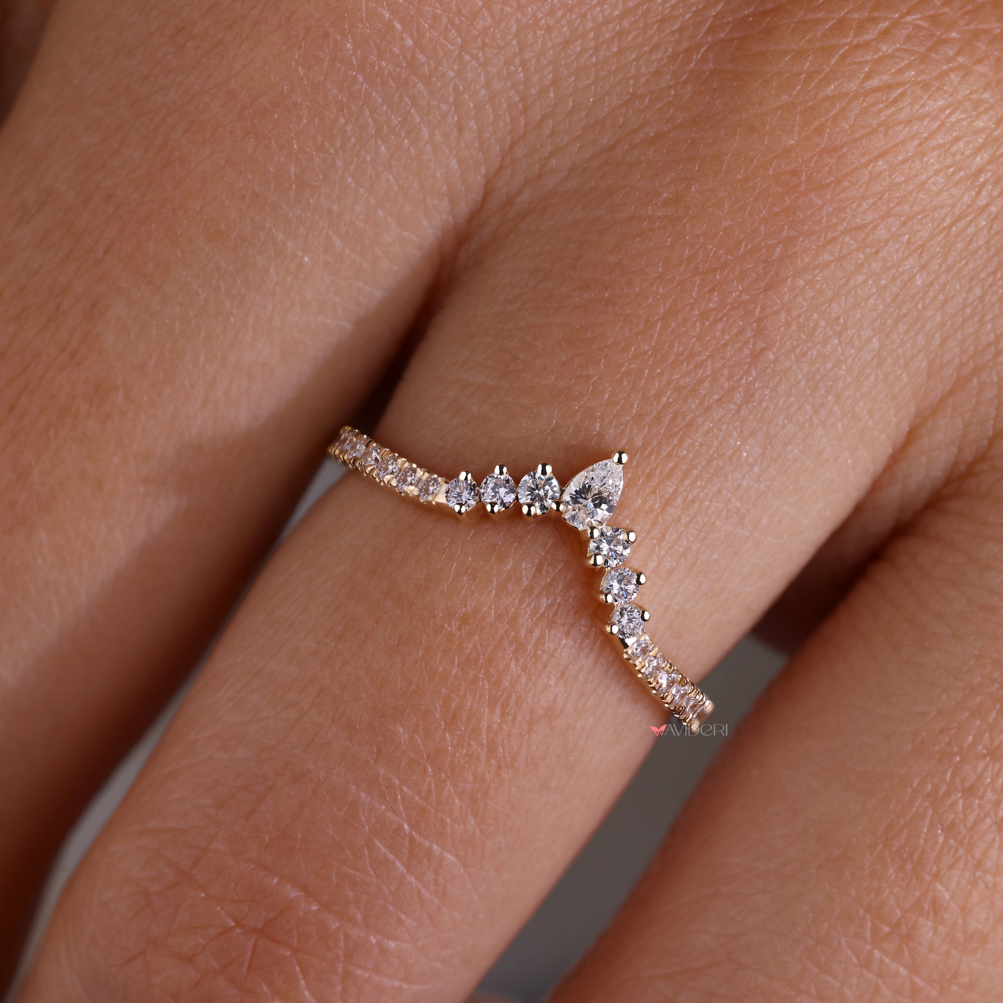 A beautiful wedding band for pear shaped ring designed to enhance its elegance and create a cohesive look.
